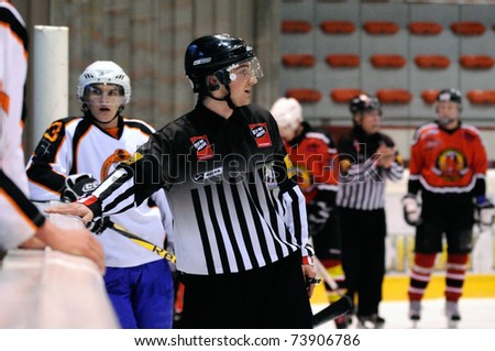 ZELL AM SEE, AUSTRIA - MARCH 19: Salzburg hockey League. Linesman trying to calm down benches. Game SV Schuettdorf vs Salzburg Sued (Result 10-4) on March 19, 2011, at the hockey rink of Zell am See.