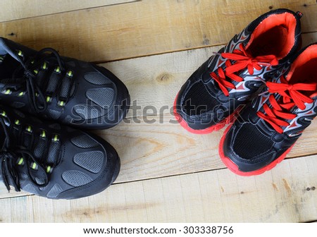 Picture of a pair of kids sport shoes on wood panels