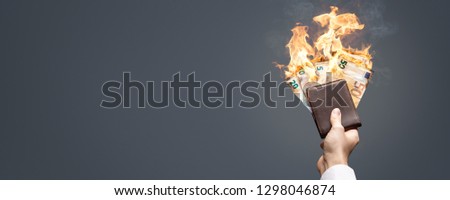 Euro bills in a wallet burning with a bright flame as a panorama Foto stock © 