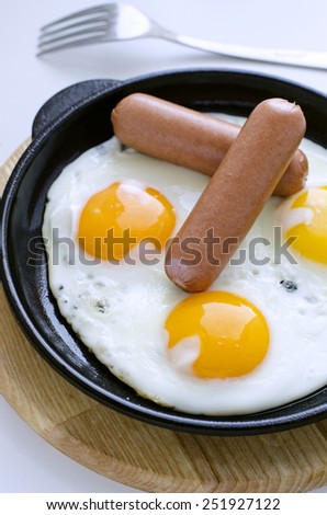 scrambled eggs and sausage in a cast iron skillet for Breakfast