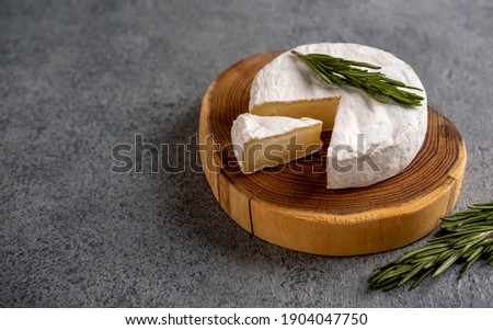 Brie cheese. Camembert cheese. Brie cheese or Camembert cheese  on a wooden board.