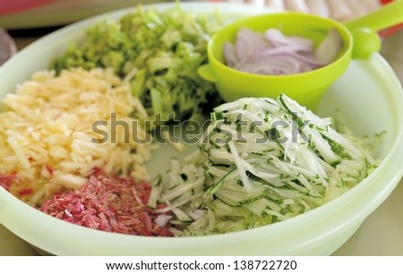 sliced cucumber, pineapples, onions, chinese lettuce and torch ginger flower.