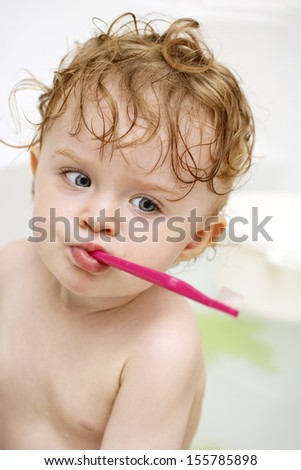 Funny little toddler with toothbrush