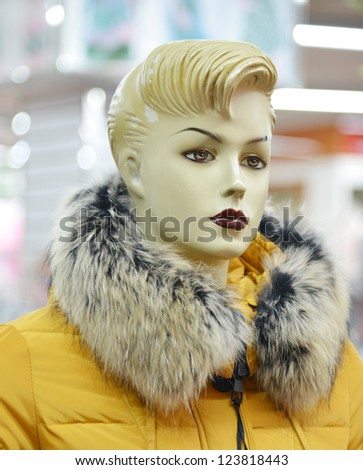 Lady mannequin in yellow fur coat.