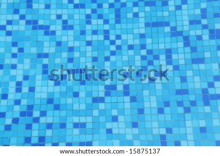 The mosaic of the swimming pool ground under water,blue seamless background.