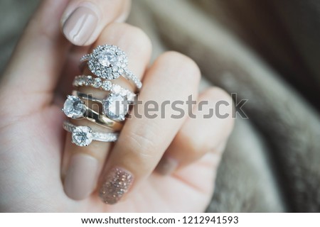 Close up of an elegant diamond rings on woman finger.love and wedding concept.soft and selective focus. Imagine de stoc © 