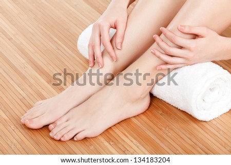 Beautiful female hands and feet with white towel