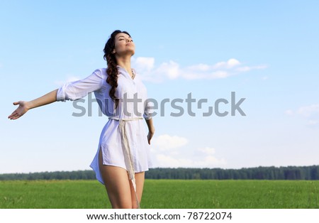 Young happy woman in green field