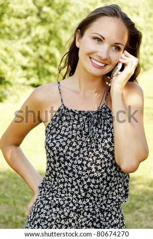 laughing young woman talking on mobile phone