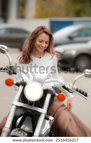 Similar – Image, Stock Photo Young long hair motorbike guy checking his phone while sitting on his old school motorbike during a break from the road route. Liberty life, young man heavy metal, white tshirt and gloves.