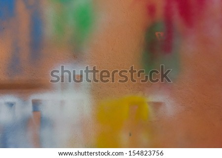 Spray paint on orange wall.