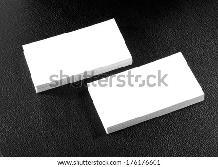 blank business cards on a black leather background