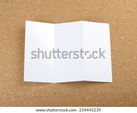 Blank folding page booklet on cork background