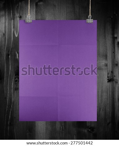 Purple poster on a wood wall