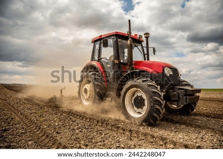 Similar – Image, Stock Photo Farmer on a tractor digs out potatoes from soil. Extract root vegetables to surface. Harvesting potatoes in autumn. Farming and farmland. Agricultural work in the field. Countryside.