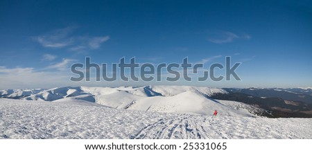 Ukrainian mountain in winter. Left (snowcapped) is Svydovets - right Dragobrat. Skier go up to mountain Blyznytsia