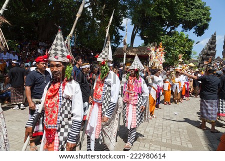 UBUD, BALI, INDONESIA - NOVEMBER 1: Traditional poleng dancers at cremation of the Queen ceremony on November 1, 2013 in Ubud, Bali. Ngaben is traditional ceremony of cremation in Bali.