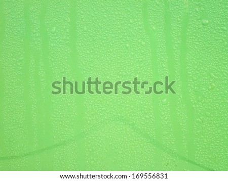 Many drops on green wavy background making texture