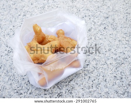 deep-fried dough stick in plastic bag