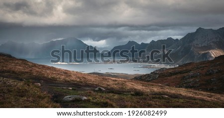 Heavy rain and sun over mountains and sea at Lofoten Islands in autumn Norway