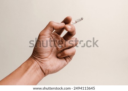 Image, Stock Photo Hand holding a cigarette