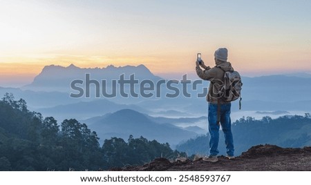 Similar – Foto Bild Mann nimmt Foto auf Kamera in nebliger Natur