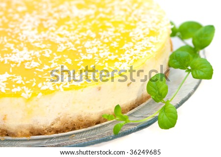 Delicious cheesecake with mango decorated with mint isolated on white