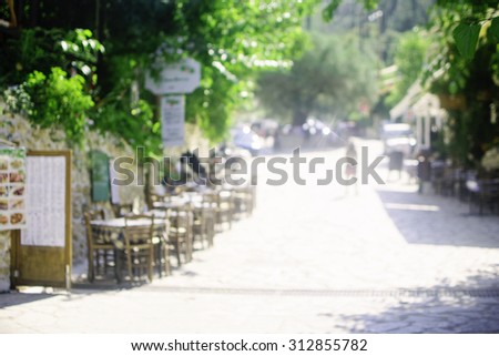 blurred cafe to sit and enjoy a eat and drink are surrounded by nature for background.Warm tone photo.
