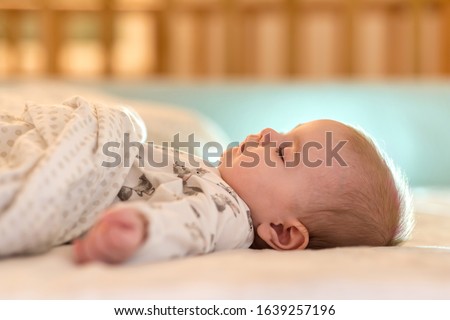 Similar – Image, Stock Photo Caucasian blonde baby seven months old lying on bed at home. Kid wearing cute clothing yellow color