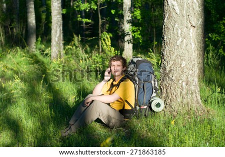 Hiker using mobile device in forest