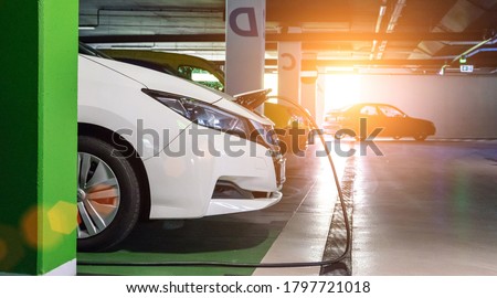 Alternative energy. Electric car charge battery on eco energy charger station. Hybrid vehicle - green technology of future. Eco-friendly alternative energy concept.