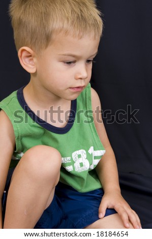 A Cute Little 3 Year Old Boy Playing On A Black Background. Stock Photo ...