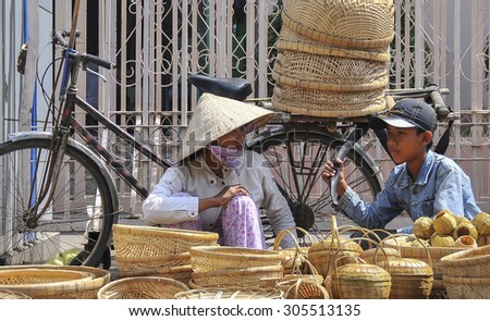 CAN THO, VIETNAM - JAN 18: Sister and brother selling rattan baskets in Can Tho on Jan 18th, 2009.