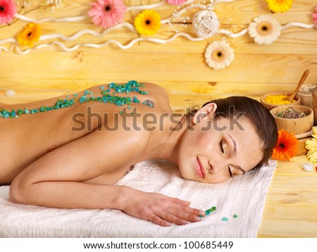 Woman getting  massage body salt scrub.
