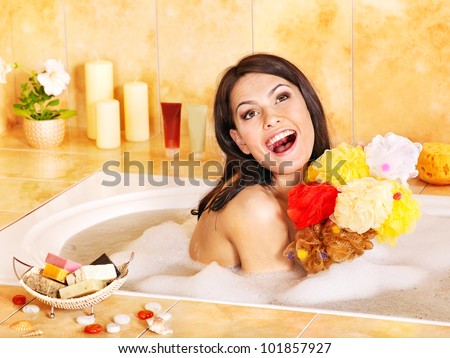 Young woman take bubble  bath. Group bath sponge.