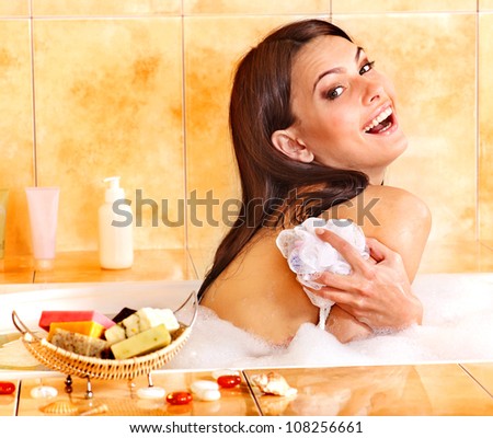 Young woman take bubble  bath. Skincare.