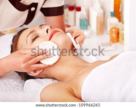 Young woman getting facial  massage in beauty spa.