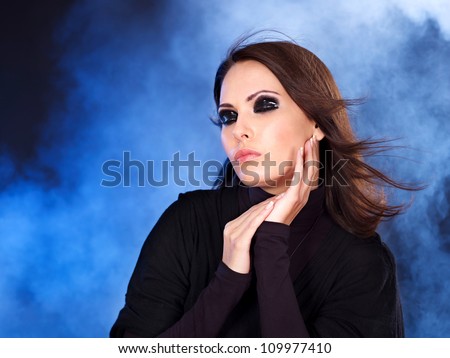 Fashion studio shot of young and woman in fog.