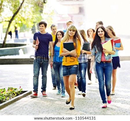 Group student with notebook on outdoor.