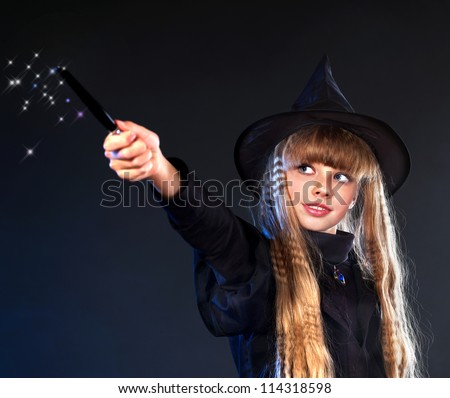 Girl in witch\'s hat with magic wand casting spells.