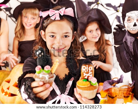Halloween party with group children holding trick or treat.