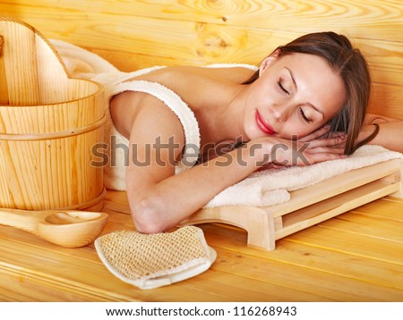 Young woman in sauna. Healthy lifestyle.