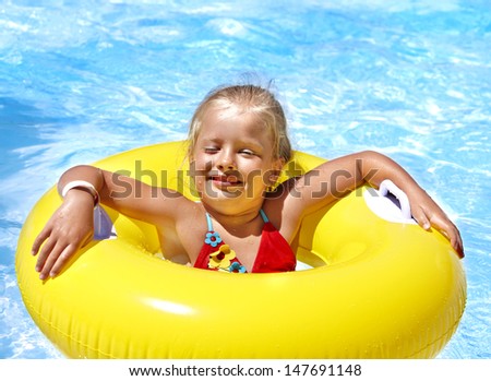 Child  on inflatable ring in swimming pool.