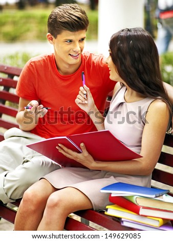 Couple student with book summer outdoor.