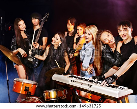 Musical group male and female  performance in night club.