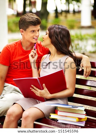 Couple student with book summer outdoor.