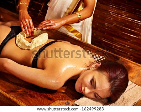 Young woman having stomach  spa treatment.
