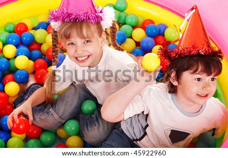 Children in party hat with ball.