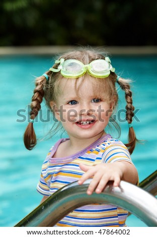 Child in protective goggles leaves pool. Outdoor.