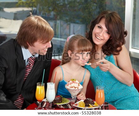 Happy family with child in cafe. Parenting.
